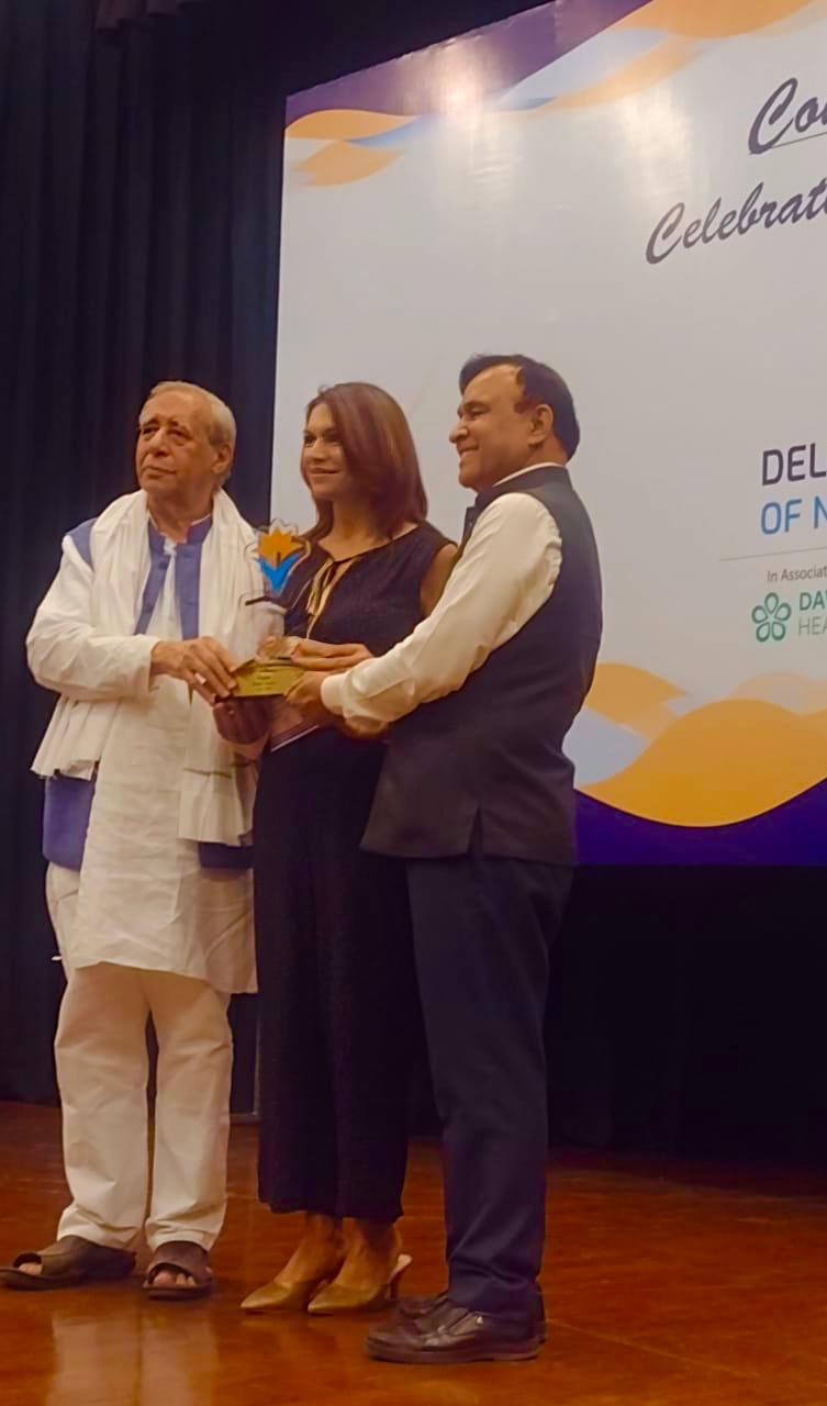 Dr. Deepti Verma receiving an honour on stage in New Delhi