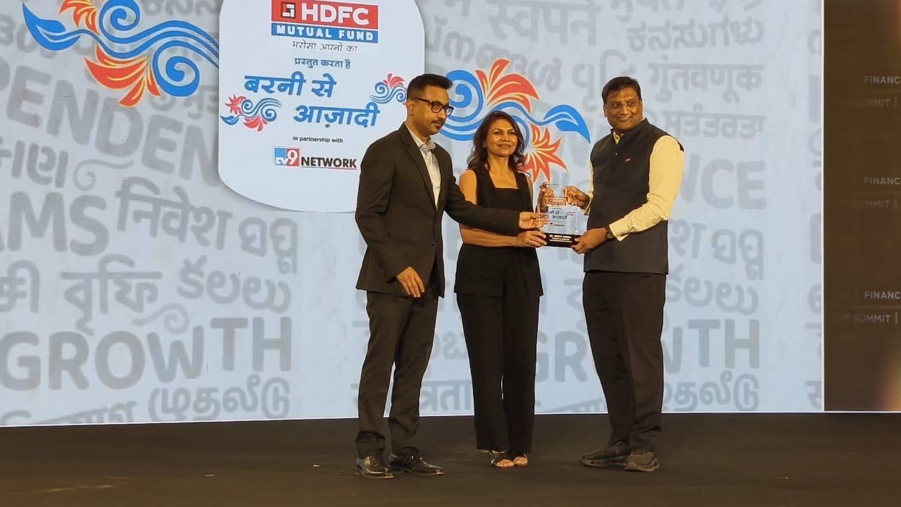 Dr. Deepti Verma speaking on stage at a financial freedom summit