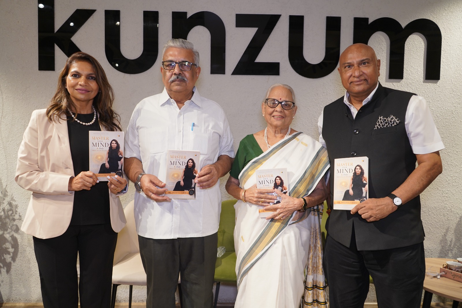 Dr. Deepti Verma with guests holding Master Your Mind & Body at the launch
